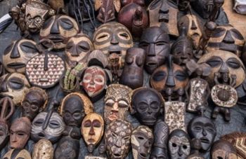 Collection of African masks on sale in Nairobi. As African art has become more popular to travelers and tourists, much of what was sacred has become mass-produced and commercially sold.