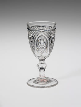 This pressed glass wine glass, made c. 1860-70 at the New England Glass Company, is typical of nineteenth-century American factory glass products.