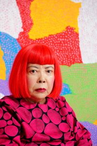 Yayoi Kusama enjoys the spotlight, and is usually seen in her signature red wig and polka-dot clothing.