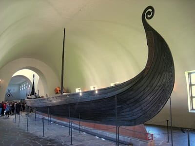 The Vikings carved ornate burial longboats, like this example from 820, which included curved lines and animal motifs.