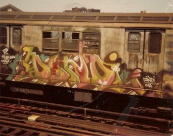 In the 1970s and 1980s, graffiti artists in New York City “tagged” (painted their name on) subway cars, which allowed their names to be seen by people in various locations in the city. Simply scrawled tags became more ornate bubble-type letters, called “throw-ups”, as seen in this piece by DONDI, photographed in 1979.